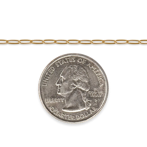 Gold-filled paperclip chain next to a quarter on a white background
