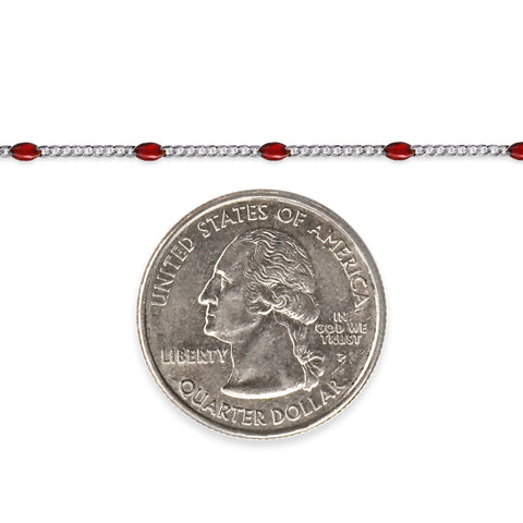 Silver chain with red enamel next to a quarter for scale
