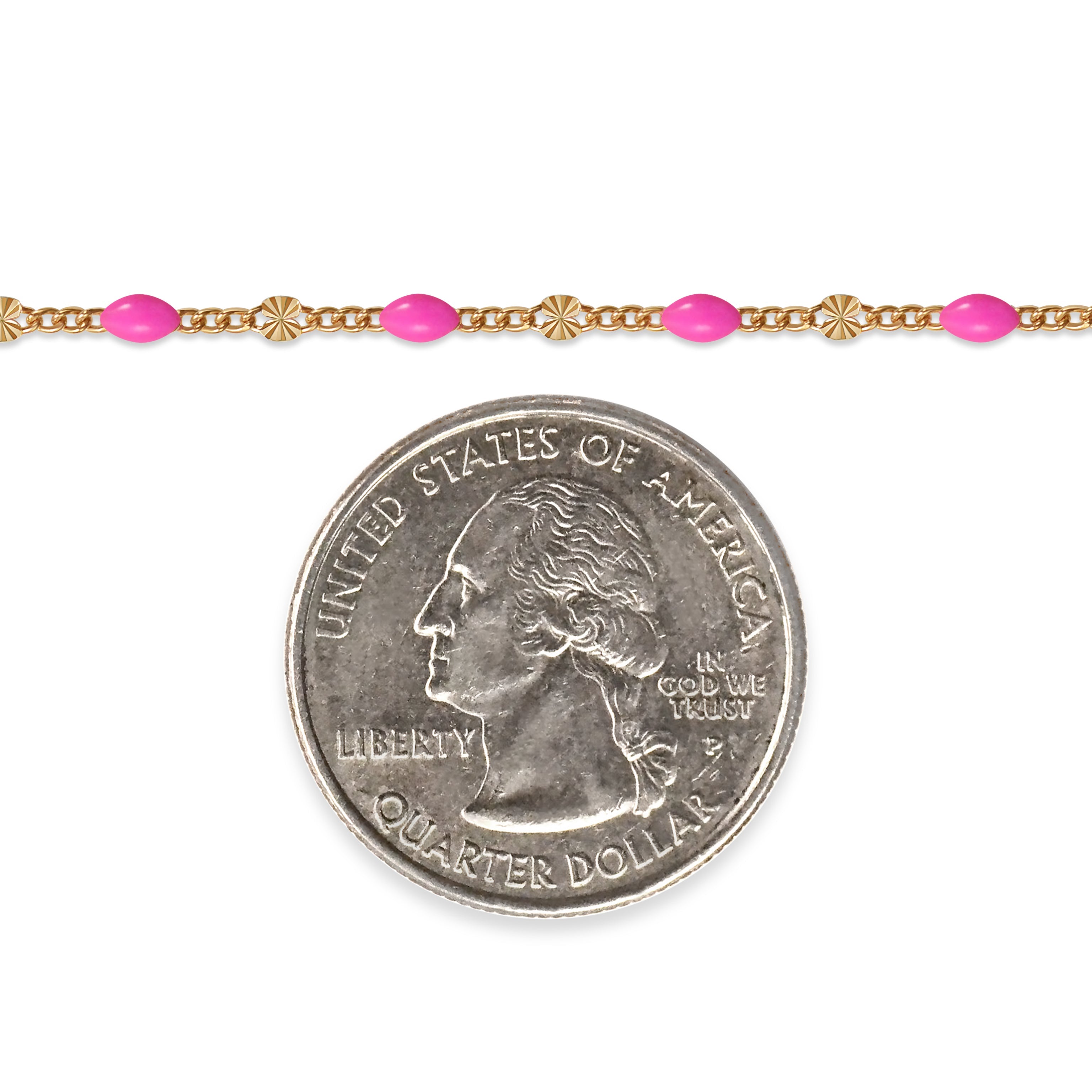 Gold filled chain with pink enamel next to a quarter on a white background