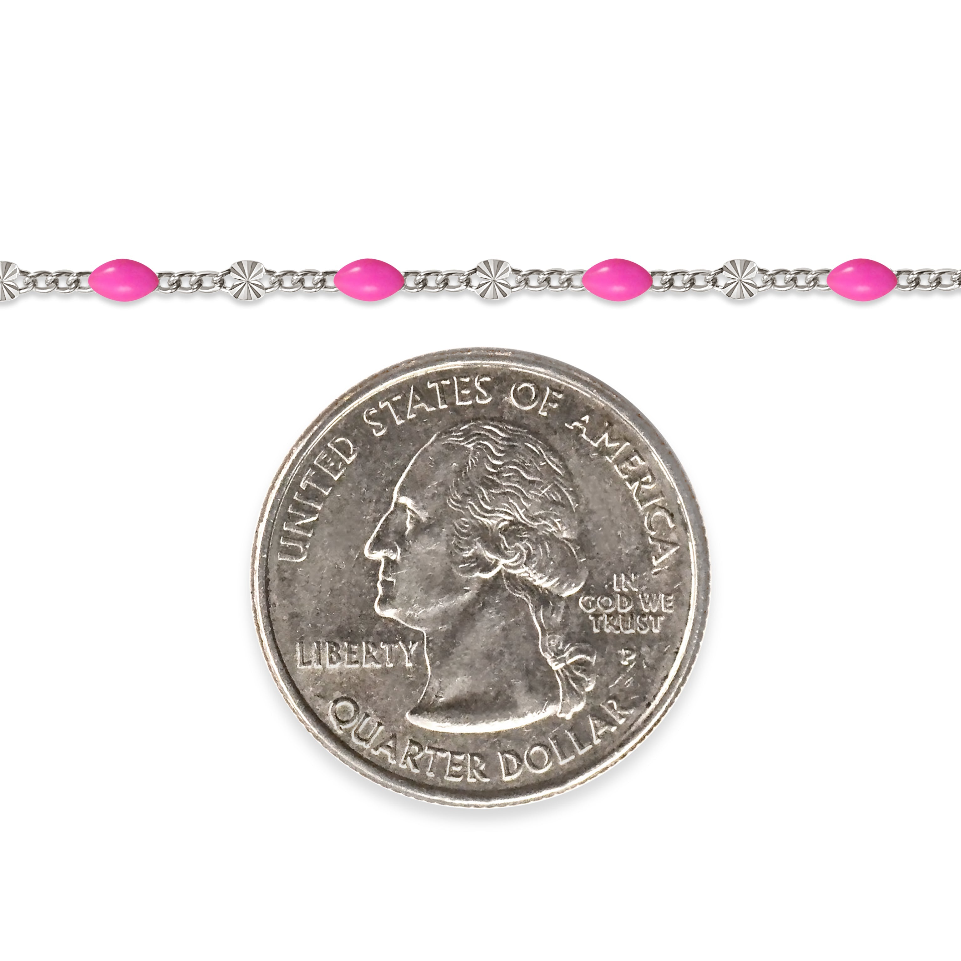Sterling silver chain with pink enamel next to a quarter