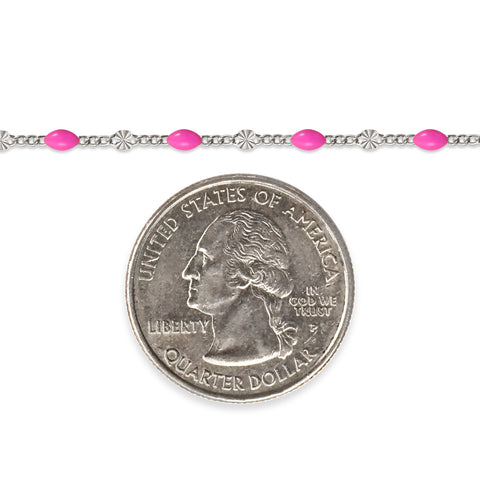 Sterling silver chain with pink enamel next to a quarter