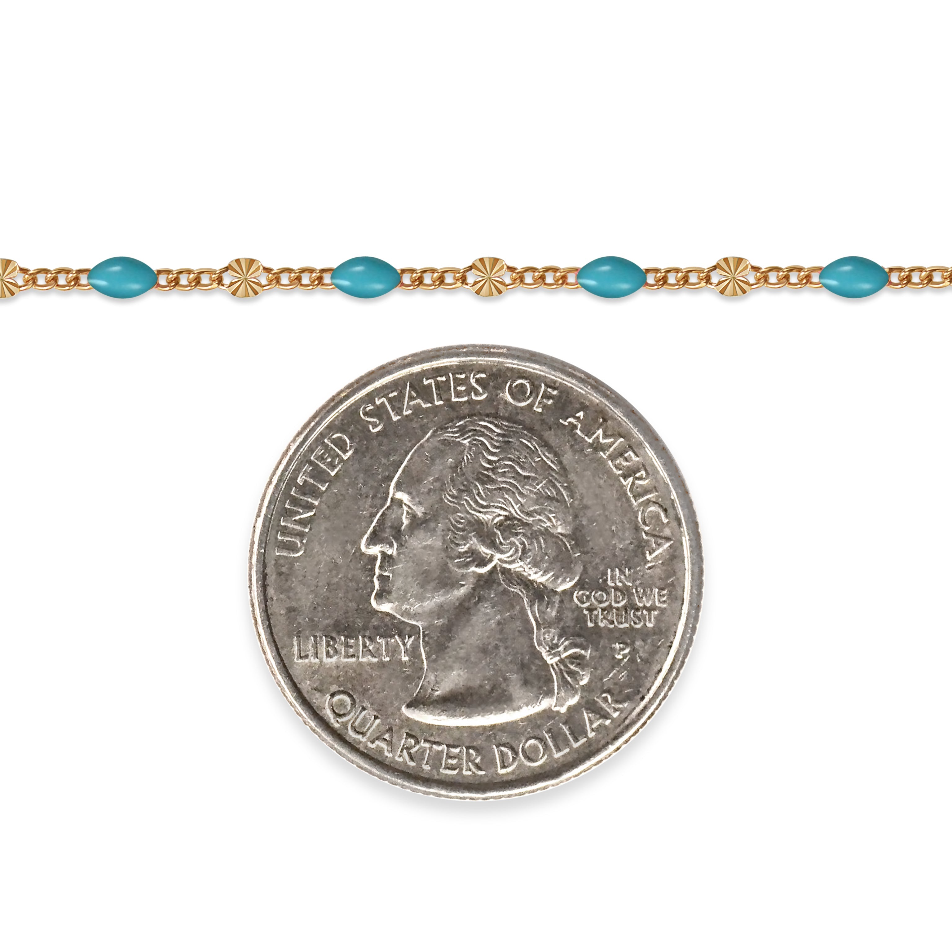 Gold filled chain with blue enamel next to a quarter on a white background