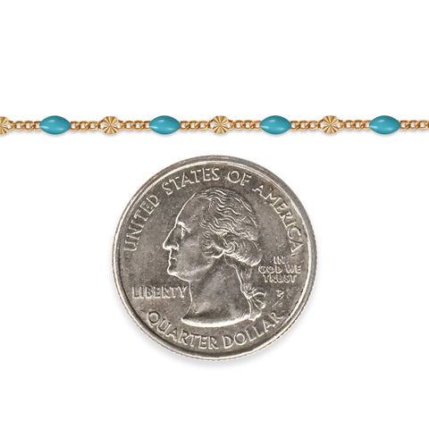 Gold filled chain with blue enamel next to a quarter on a white background