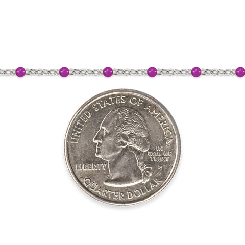 Silver chain with purple enamel beads and a quarter on a white background