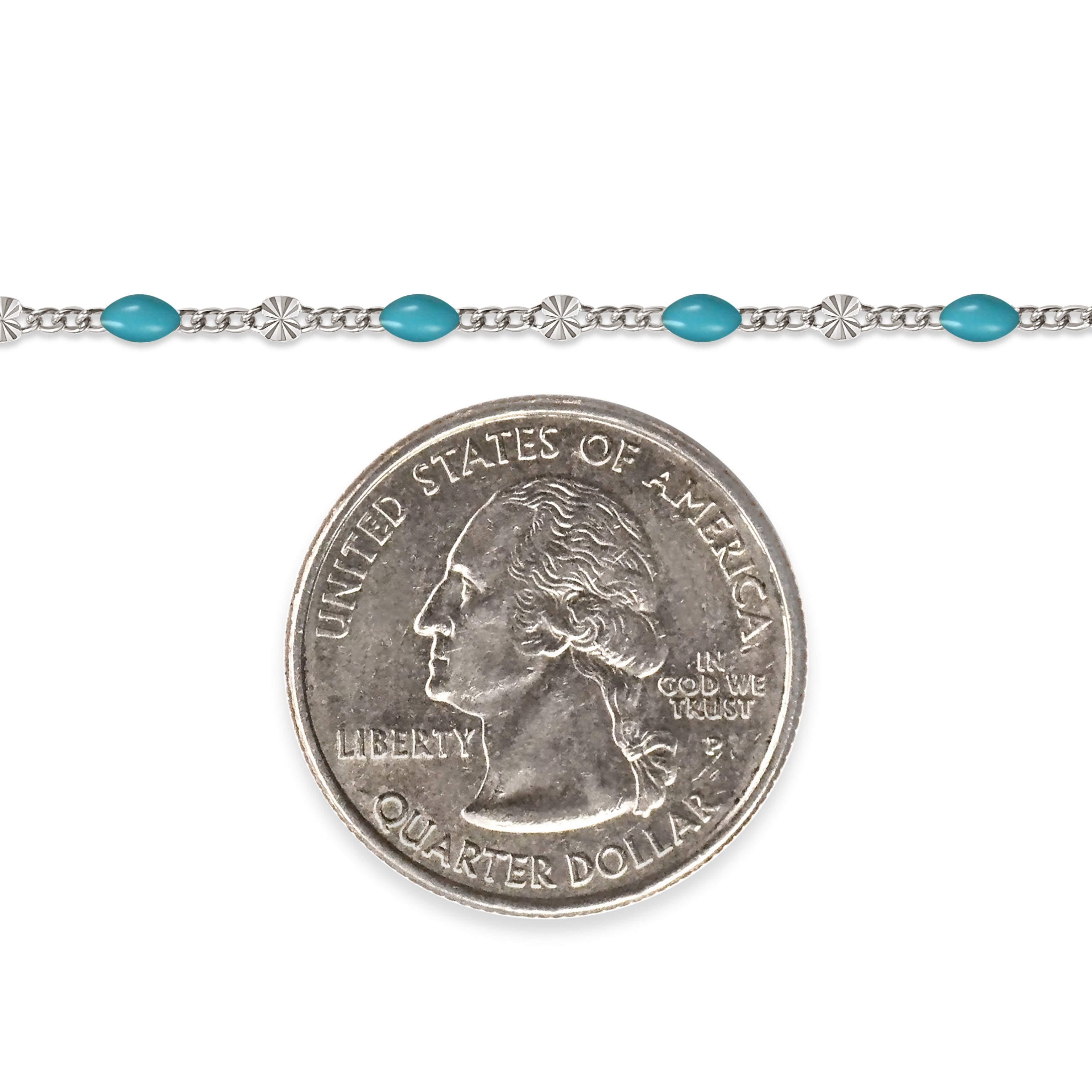 Sterling silver chain with blue enamel next to a quarter