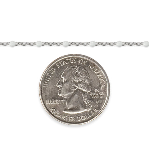 Silver chain with white enamel beads and a quarter dollar coin on a white background