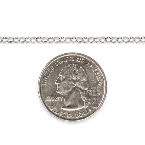 Silver chain next to a quarter dollar coin on a white background