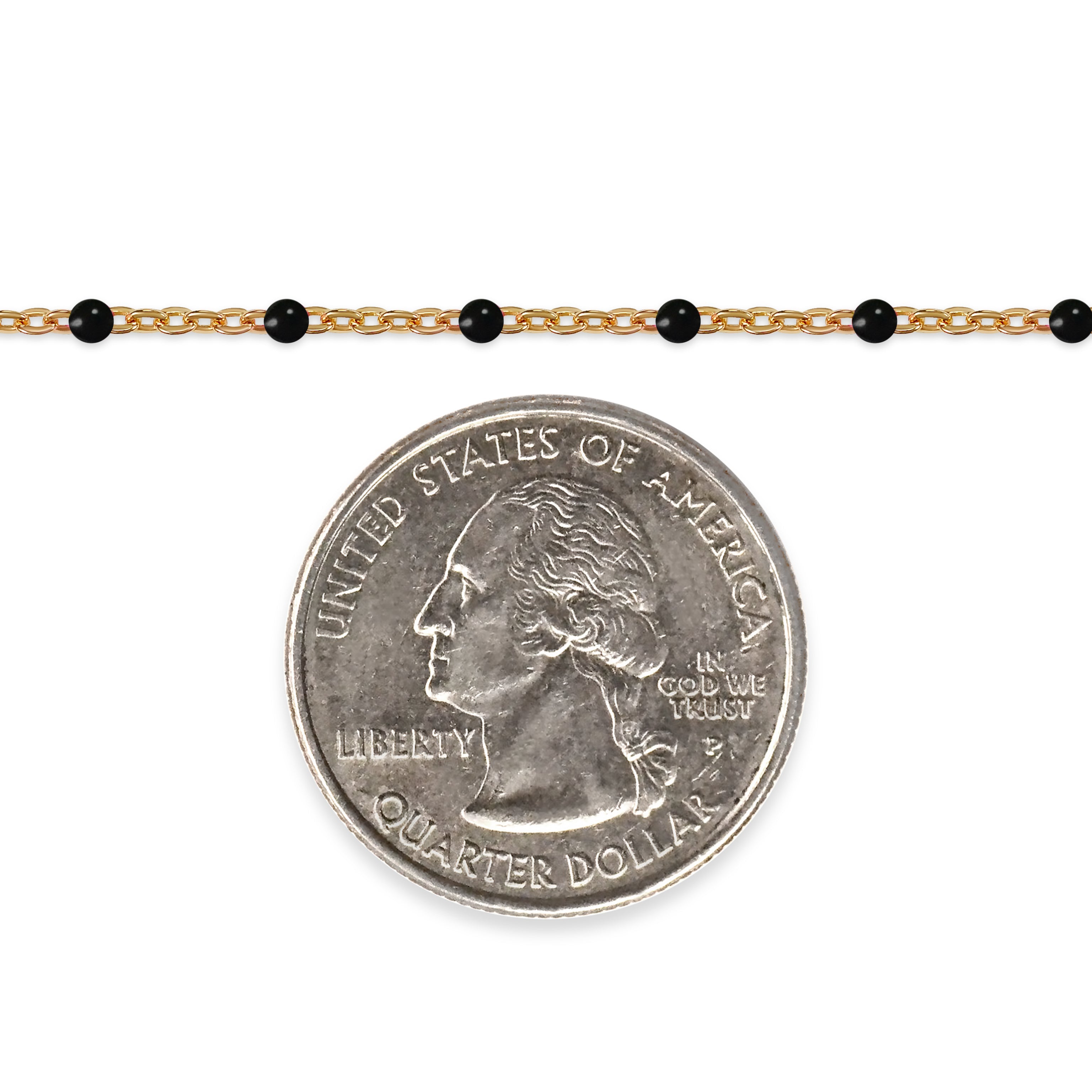 Gold chain with black beads and a quarter coin on a white background