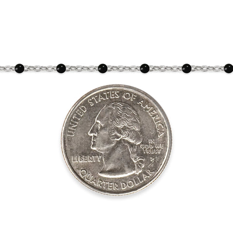 Silver chain with black enamel beads and a quarter dollar coin on a white background