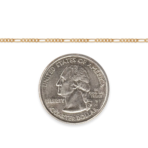 Gold-filled figaro chain next to a quarter dollar coin on a white background