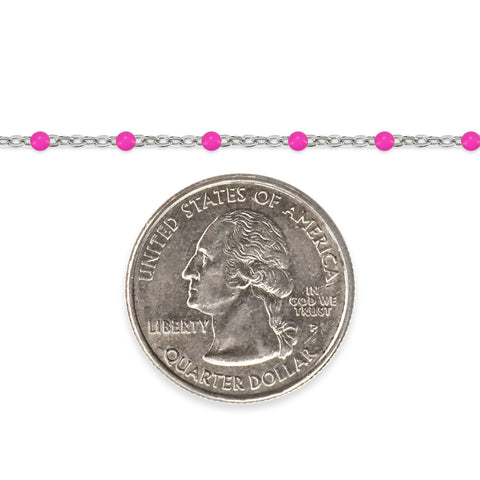 Silver chain with pink enamel beads and a quarter on a white background