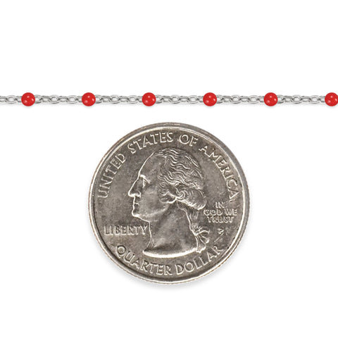Silver chain with red enamel beads and a quarter dollar coin on a white background