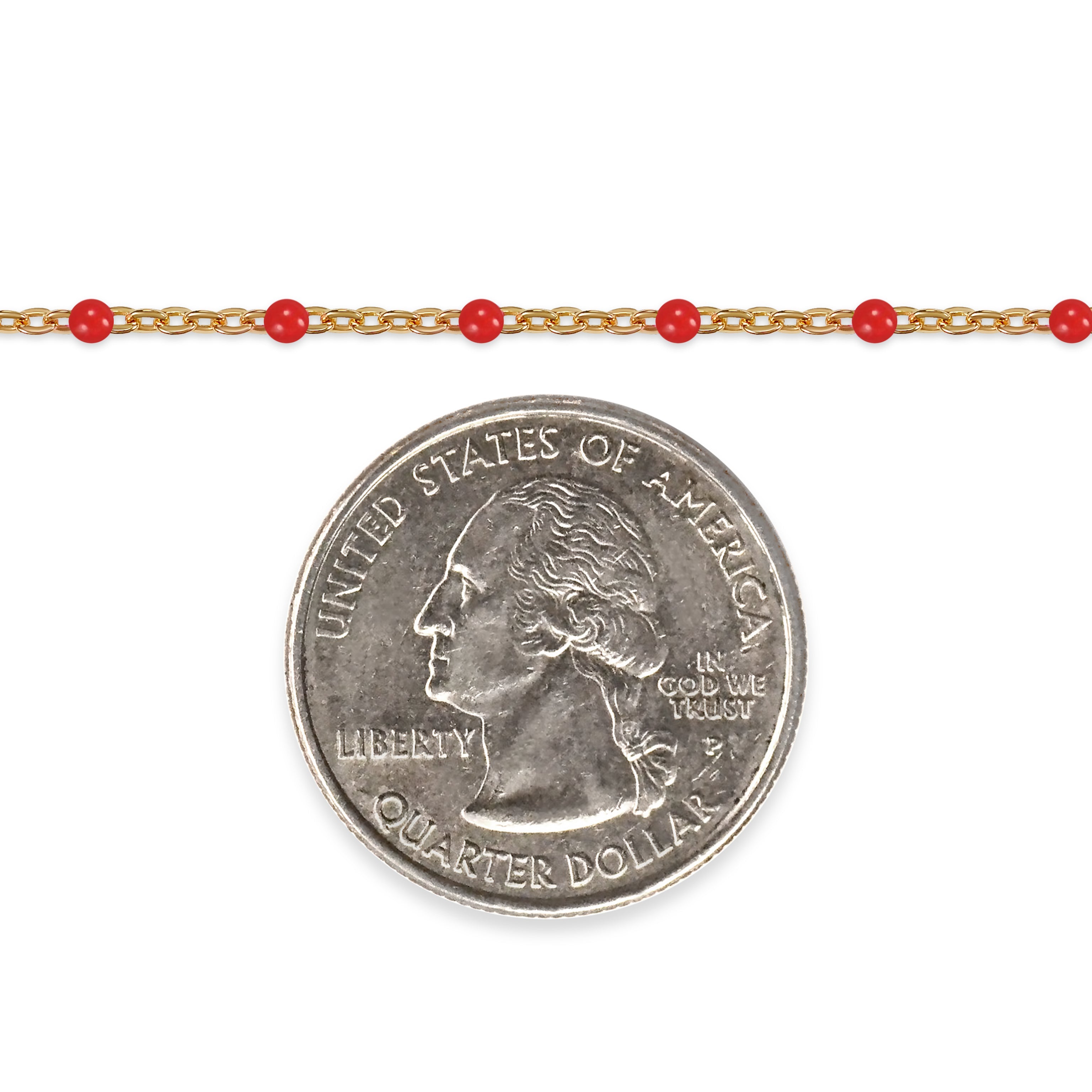 Gold chain with red beads and a quarter dollar coin on a white background
