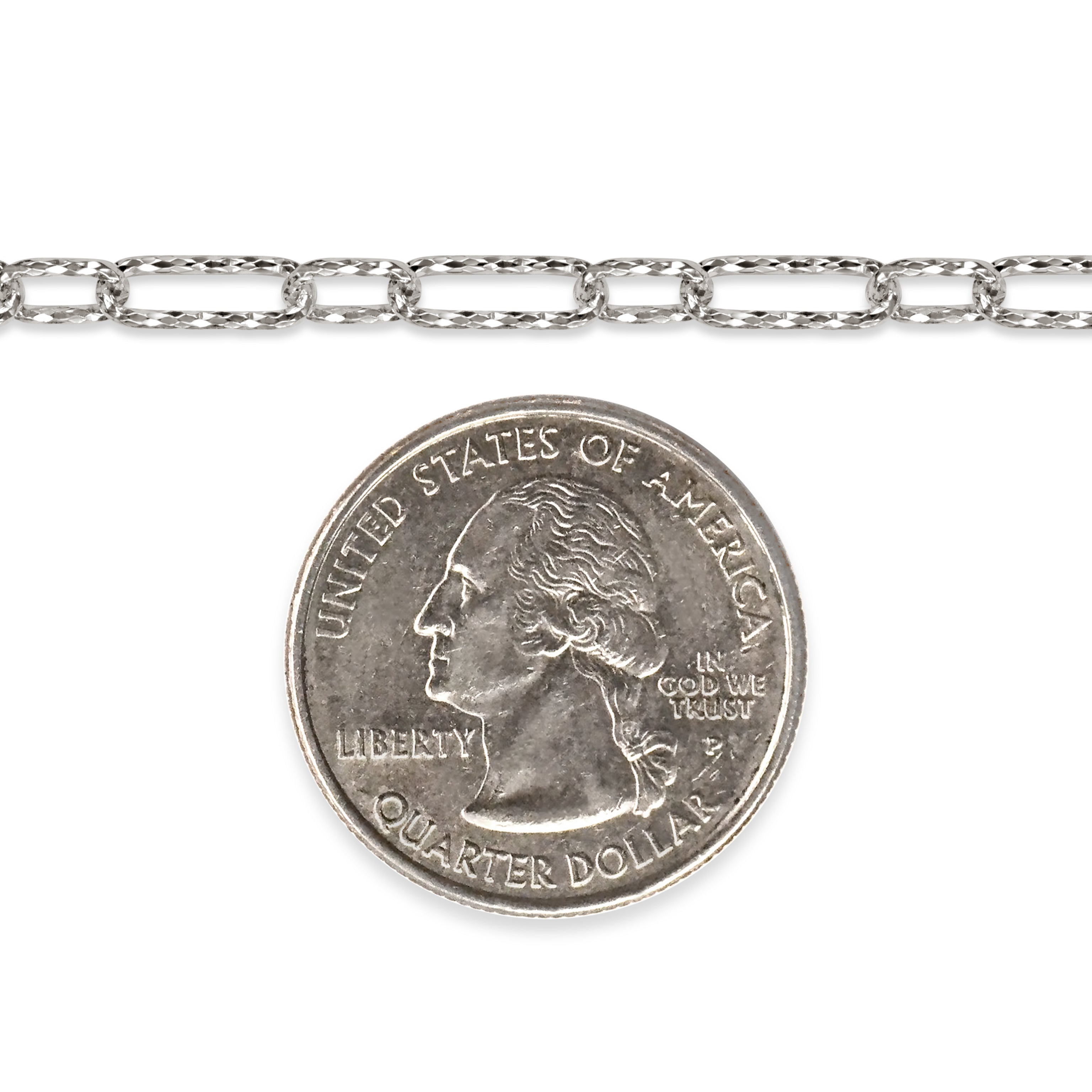 Diamond-cut sterling silver chain next to a quarter dollar coin on a white background