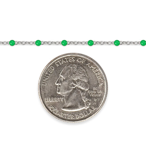 Silver chain with green enamel beads and a quarter on a white background