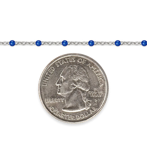 Silver chain with blue enamel beads and a quarter dollar coin on a white background