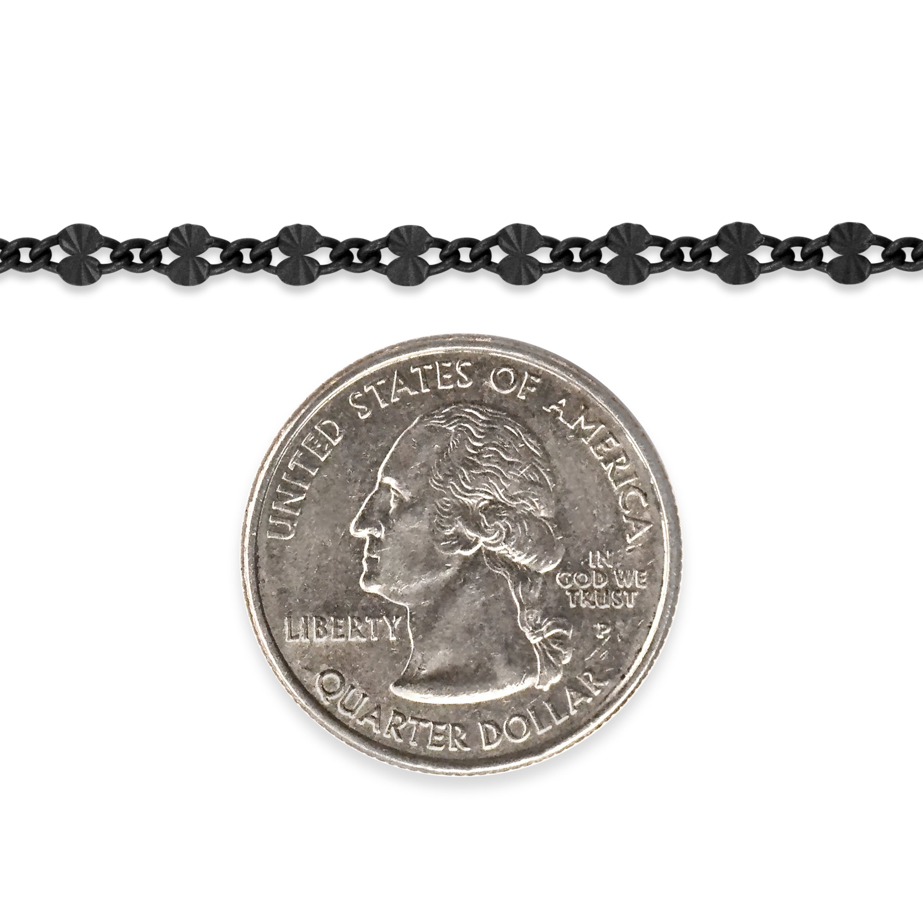 Sterling silver titanium plated chain next to a quarter dollar coin on a white background