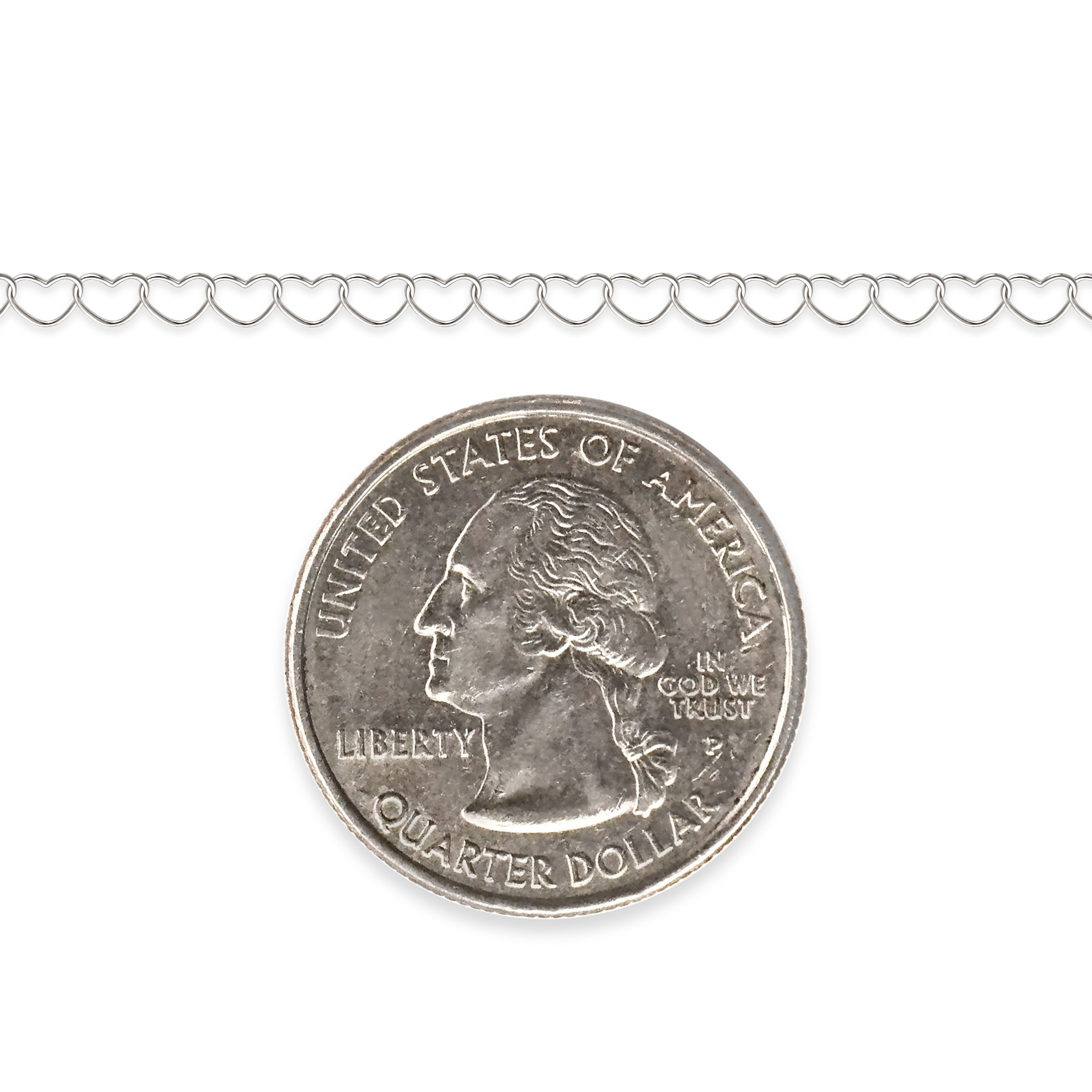 Sterling silver heart chain next to a quarter dollar coin on a white background