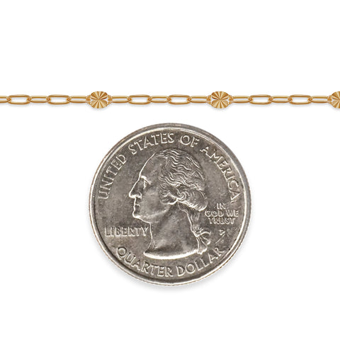 Gold chain with a quarter dollar coin on a white background