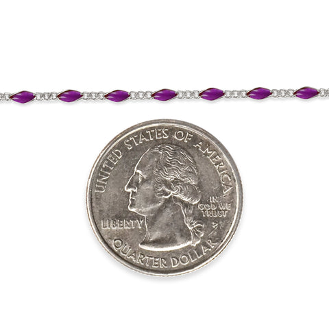 Sterling silver chain with purple enamel next to a quarter dollar coin on a white background