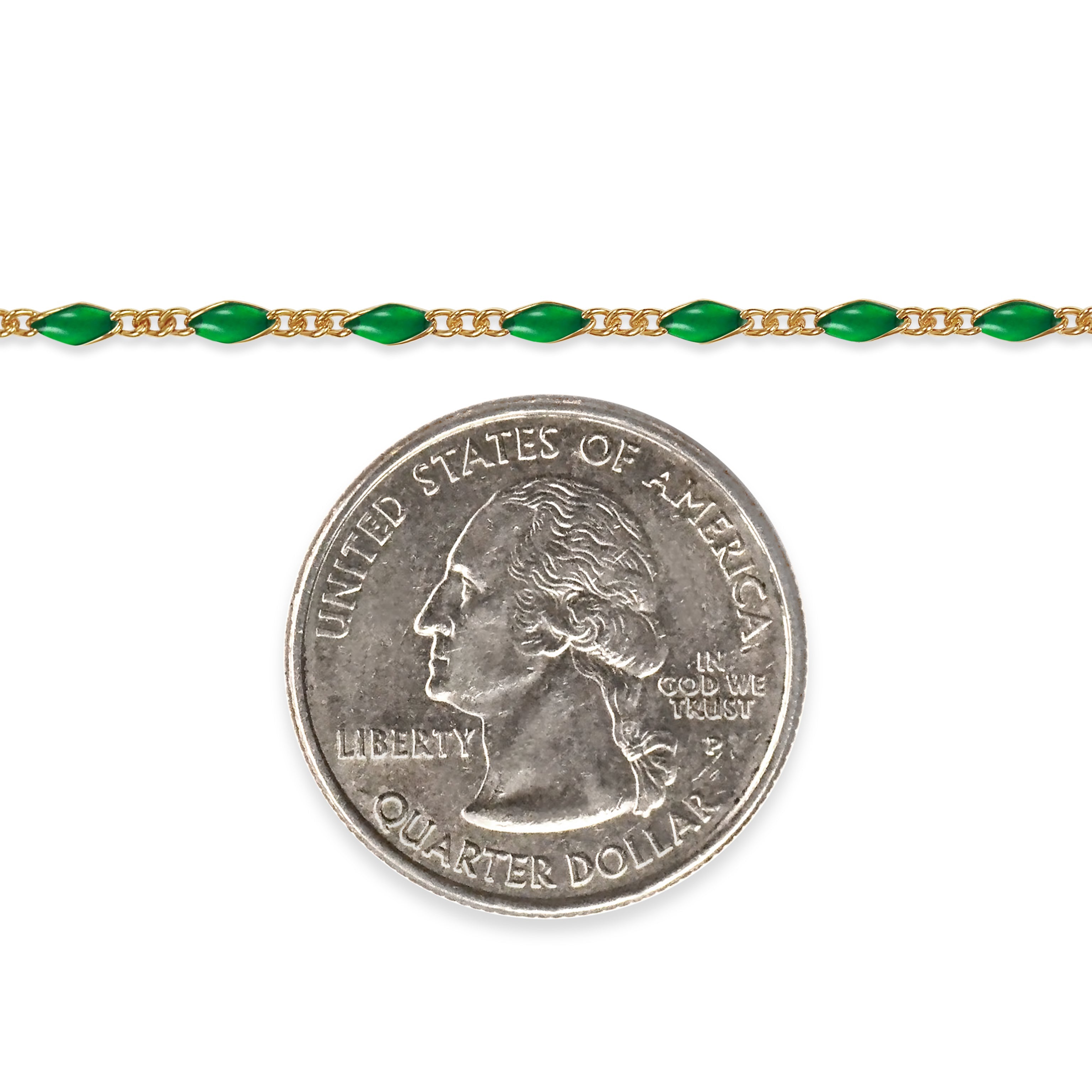 Gold filled chain with green enamel next to a quarter coin for size comparison