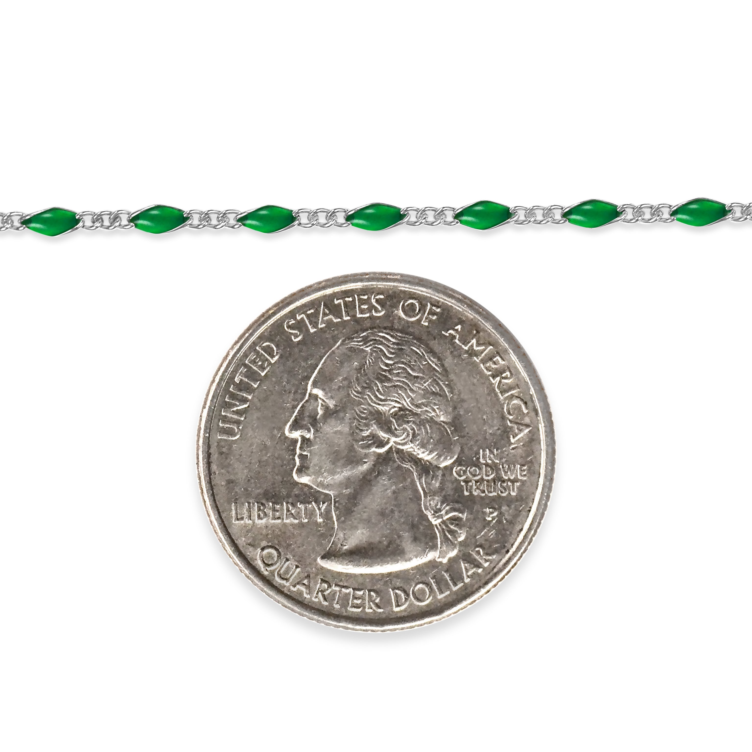 Sterling silver chain with green enamel next to a quarter dollar coin on a white background
