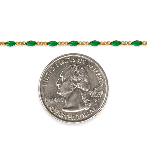 Gold filled chain with green enamel next to a quarter coin for size comparison