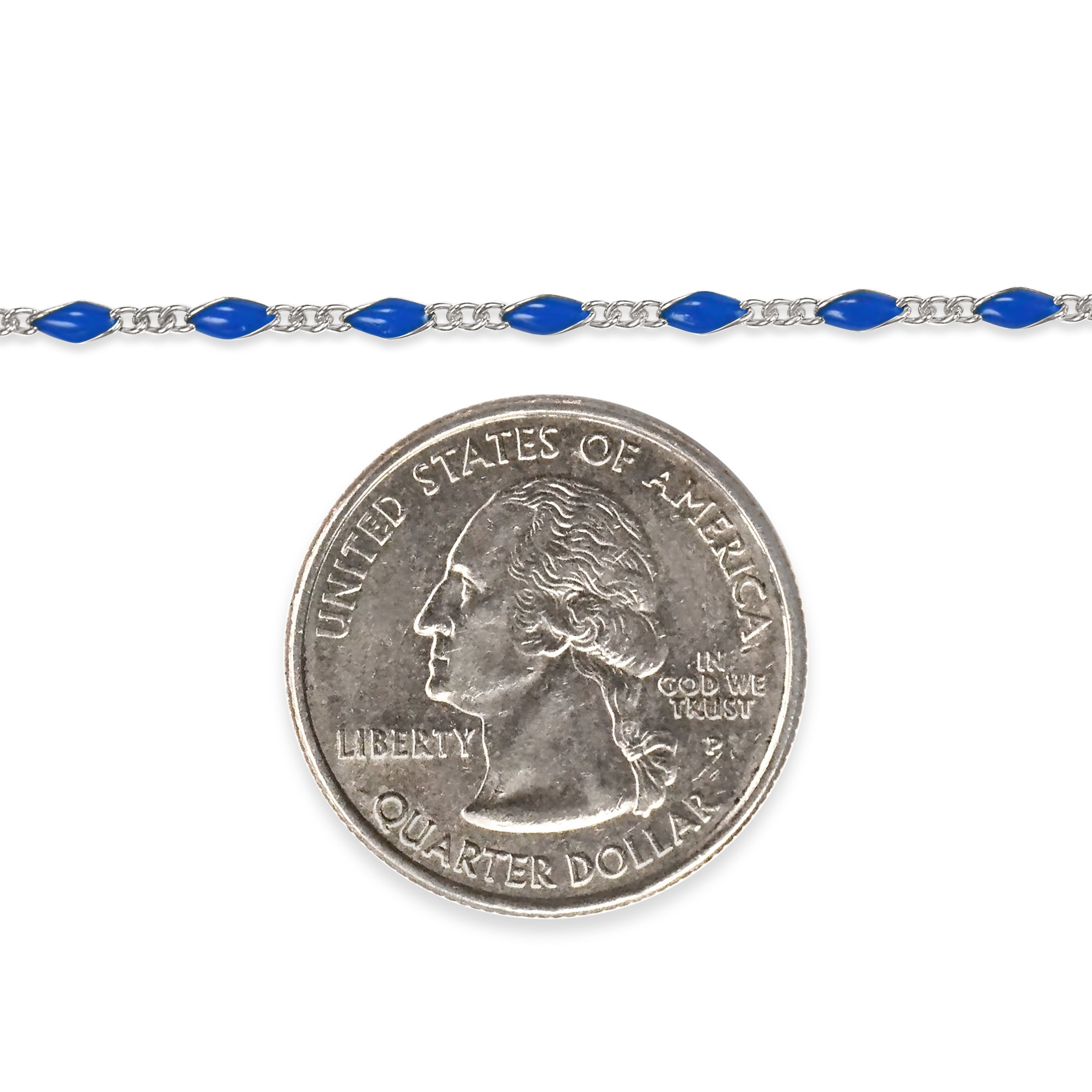 Sterling silver chain with blue enamel next to a quarter dollar coin on a white background