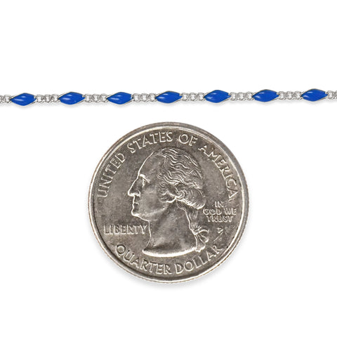 Sterling silver chain with blue enamel next to a quarter dollar coin on a white background