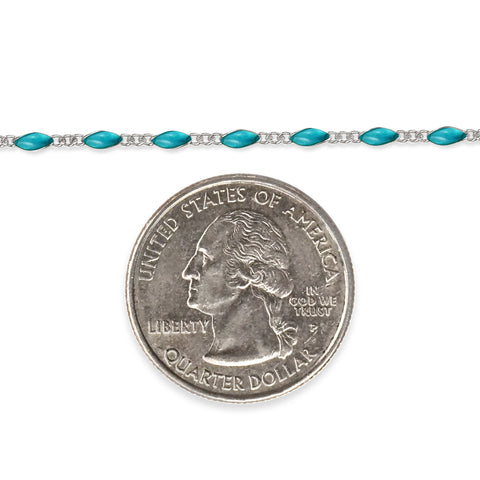 Sterling silver chain with sky blue enamel next to a quarter dollar coin on a white background