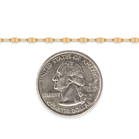 Gold-filled chain next to a quarter on a white background