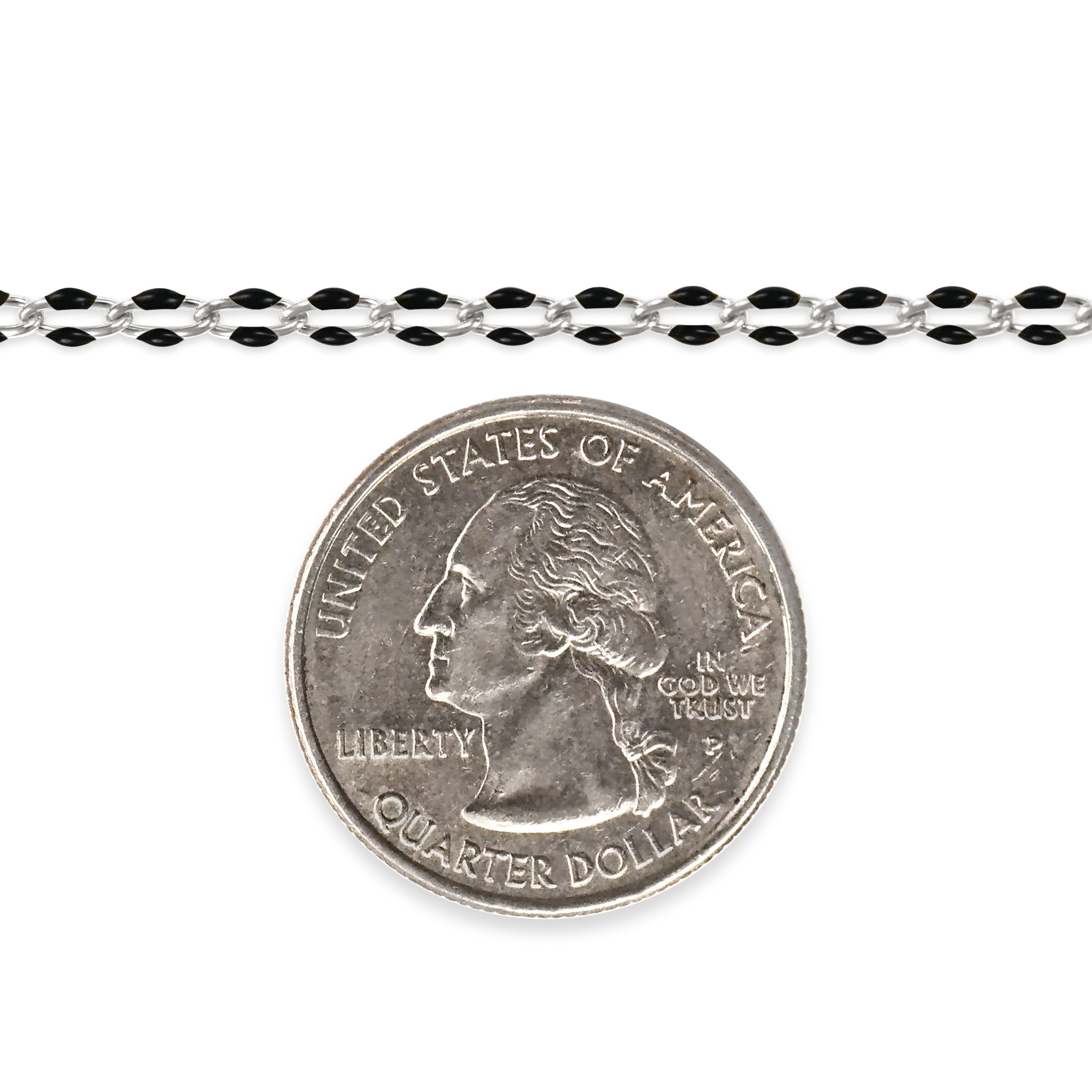 Silver chain with black enamel next to a quarter on a white background