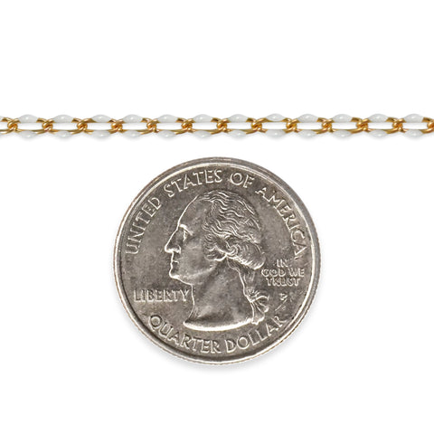 Gold filled chain with white enamel next to a quarter dollar coin on a white background