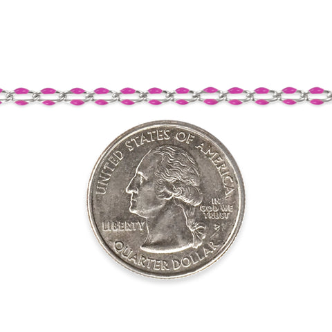 Silver chain with pink enamel next to a quarter on a white background
