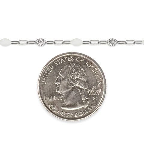 Silver chain with white enamel and a quarter dollar coin on a white background