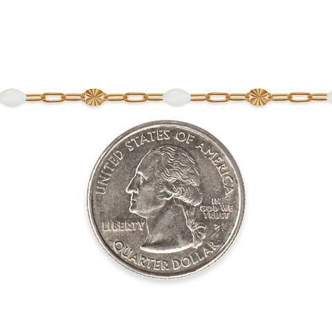 Gold filled chain with white enamel and a quarter coin on a white background