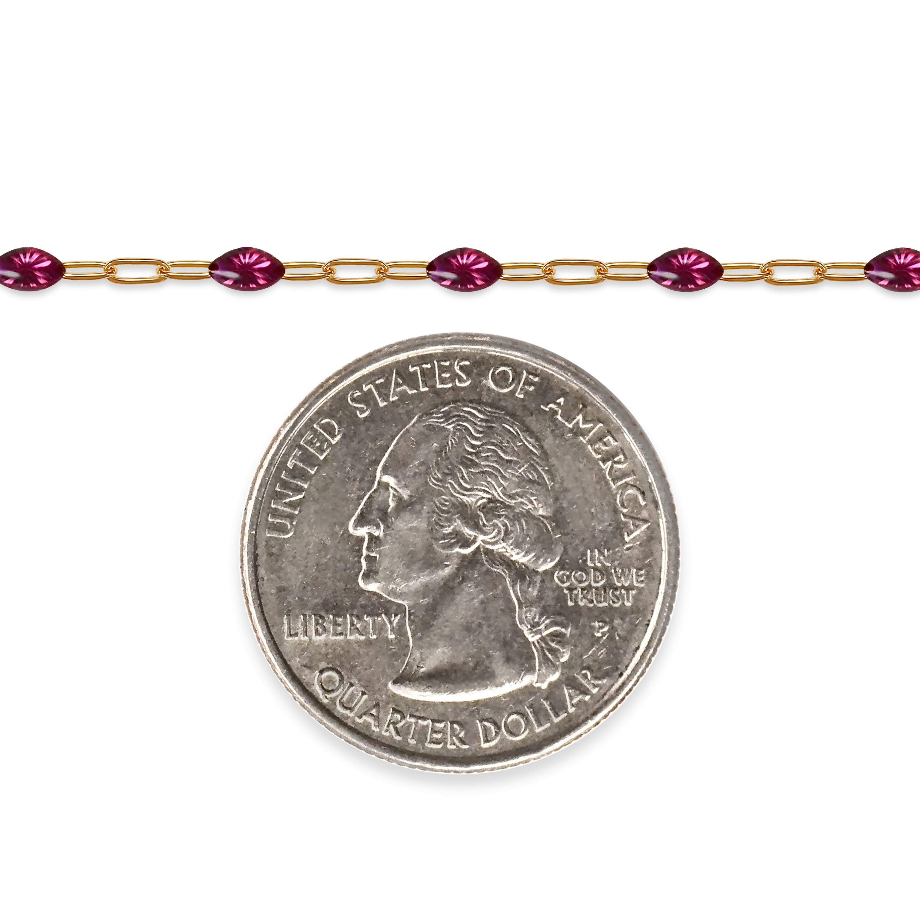 Gold filled chain with fuchsia enamel next to a quarter on a white background