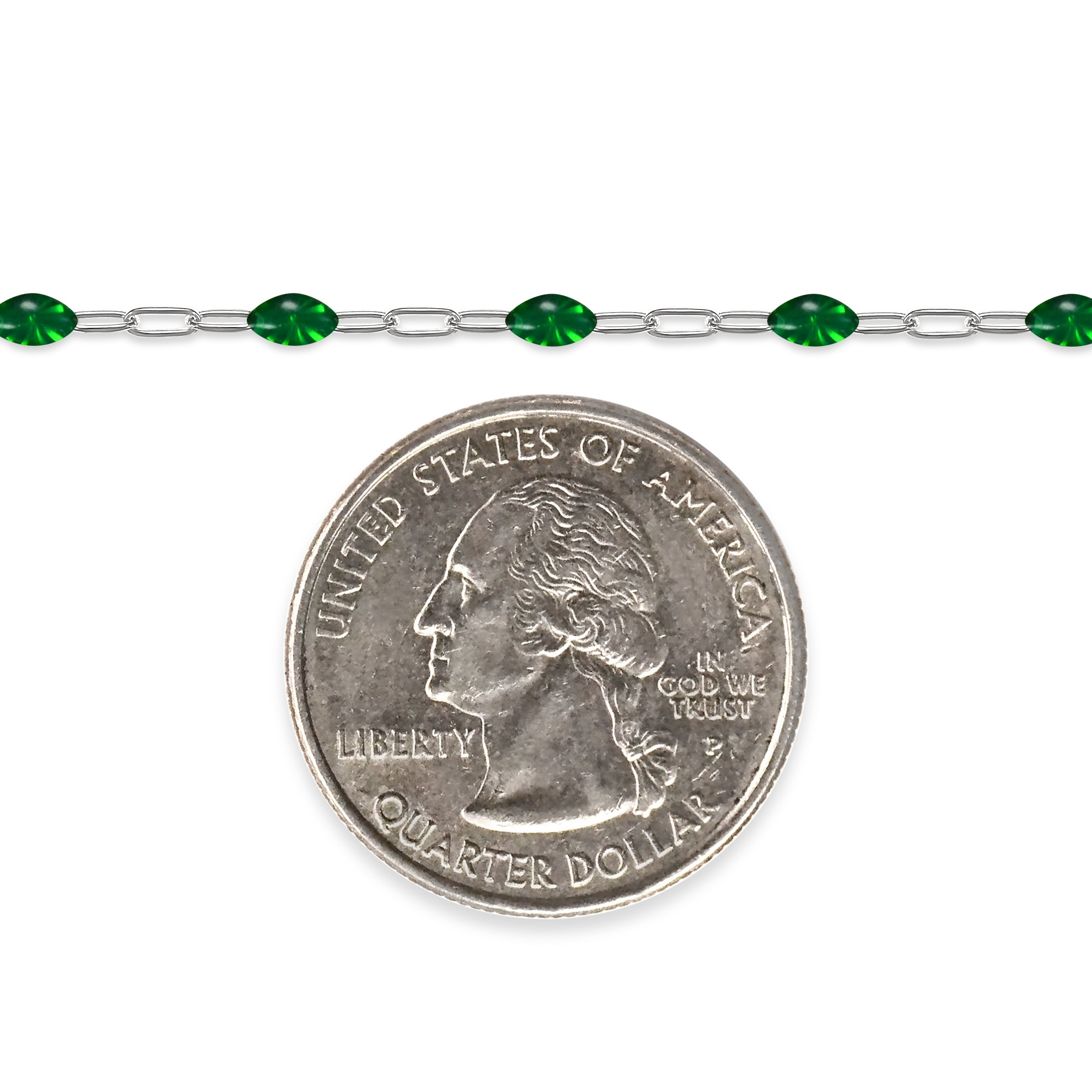 Silver chain with green enamel next to a quarter on a white background