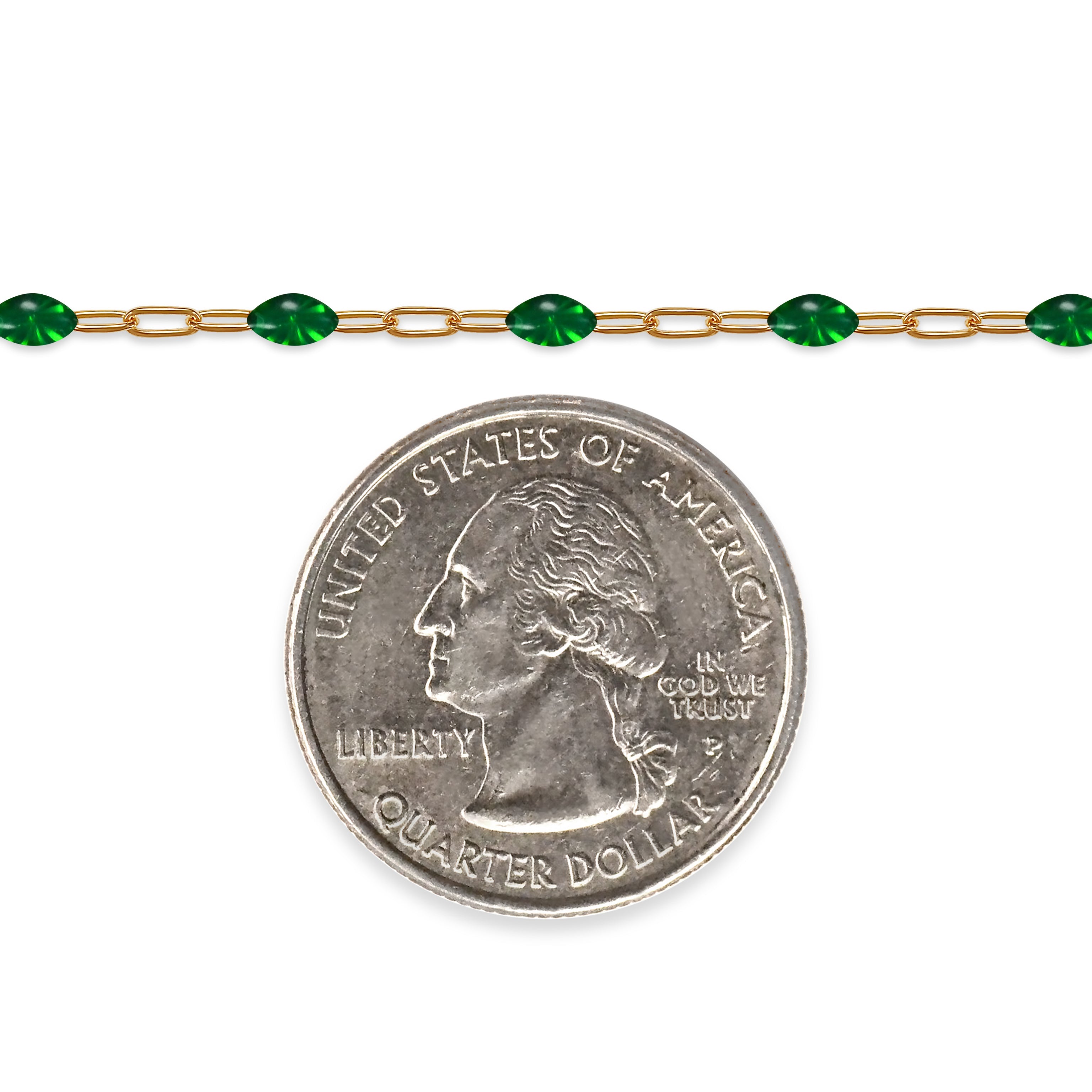 Gold filled chain with green enamel next to a quarter on a white background