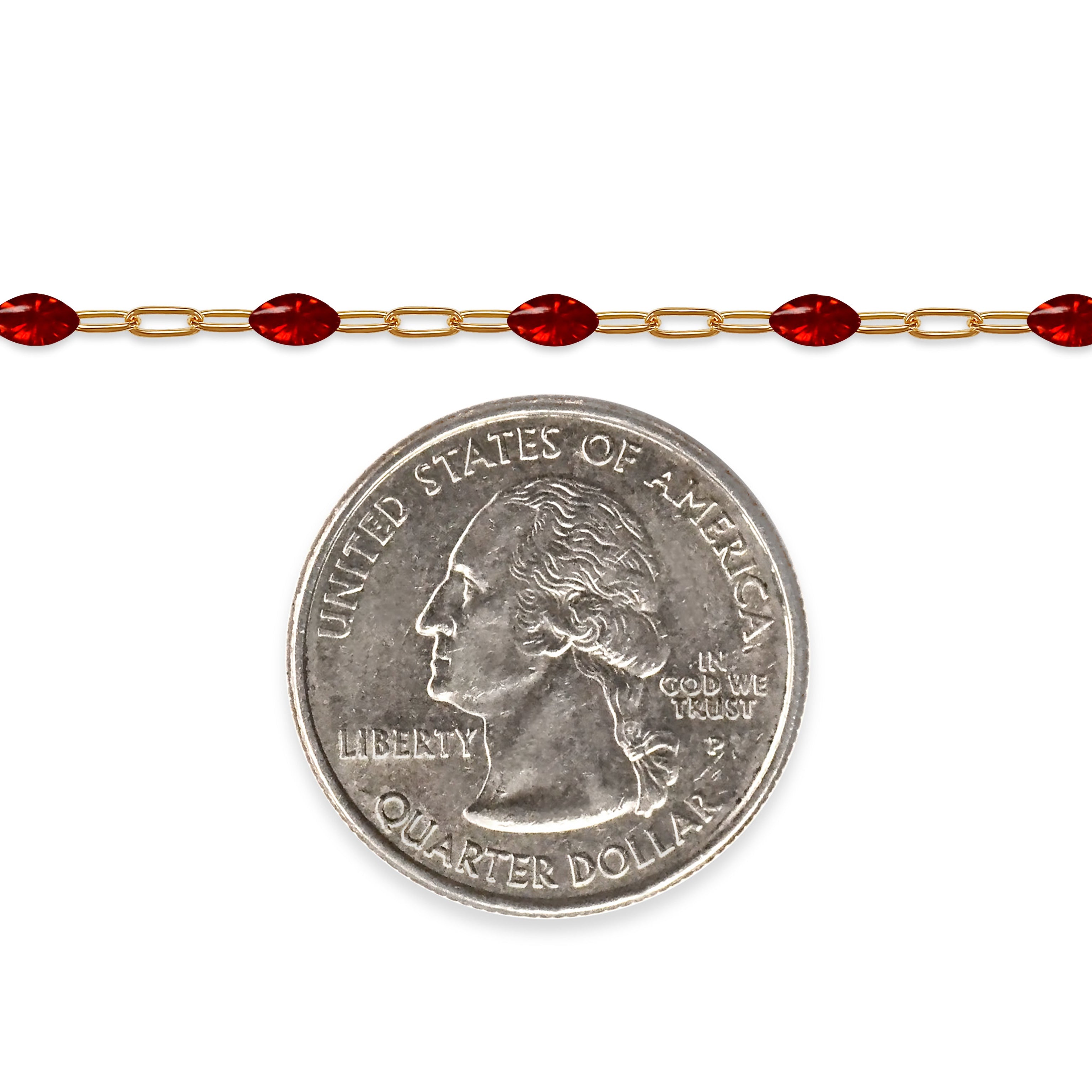Gold filled chain with red enamel next to a quarter on a white background