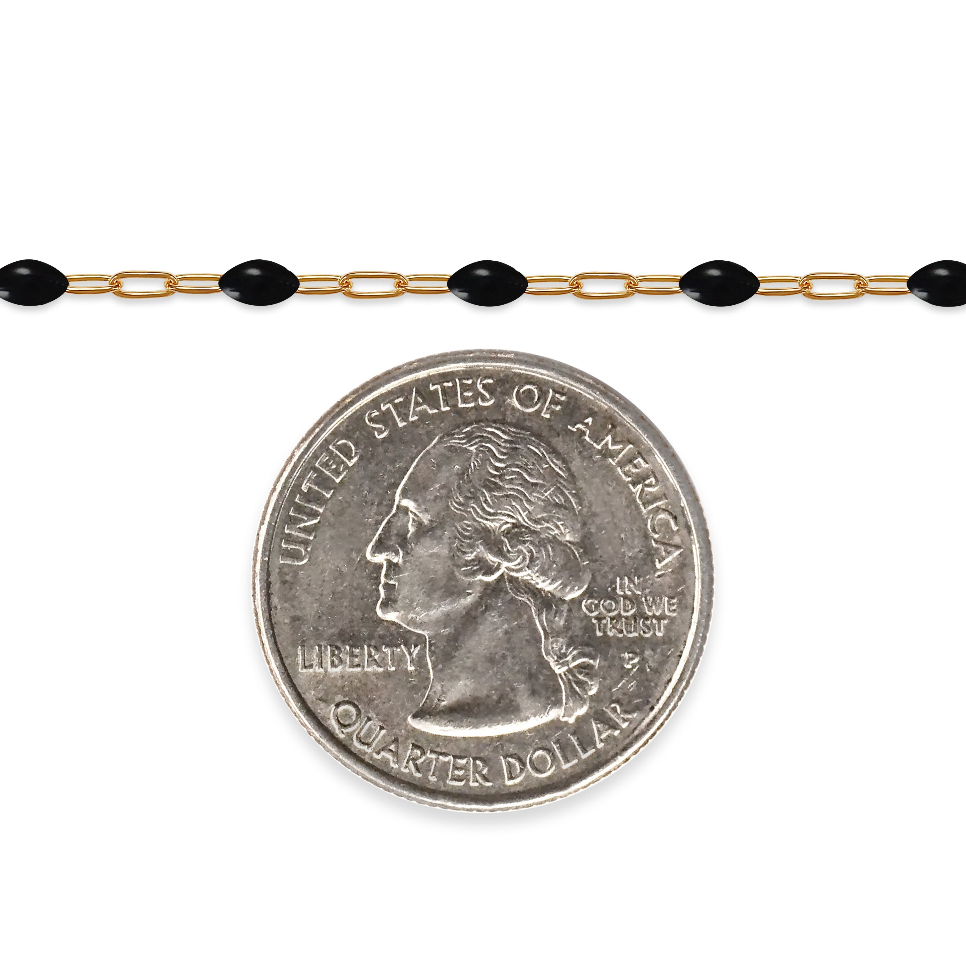 Gold filled chain with black enamel beads next to a quarter dollar coin on a white background