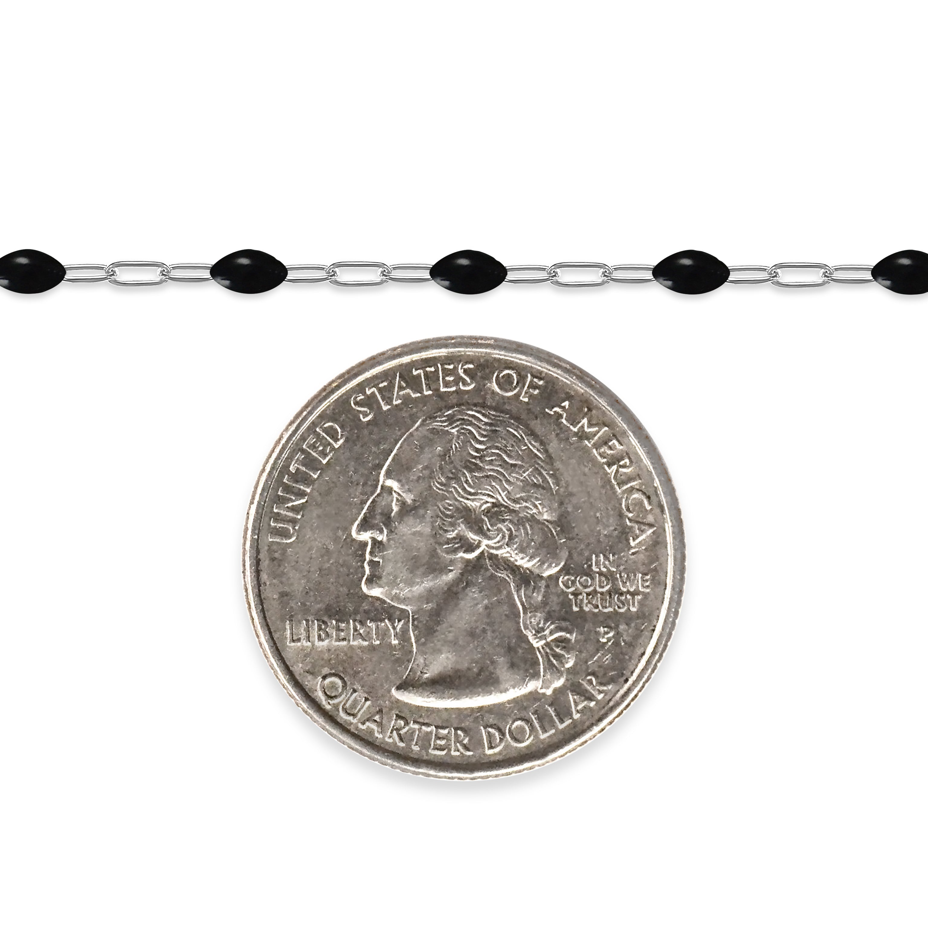 Silver chain with black enamel next to a quarter on a white background