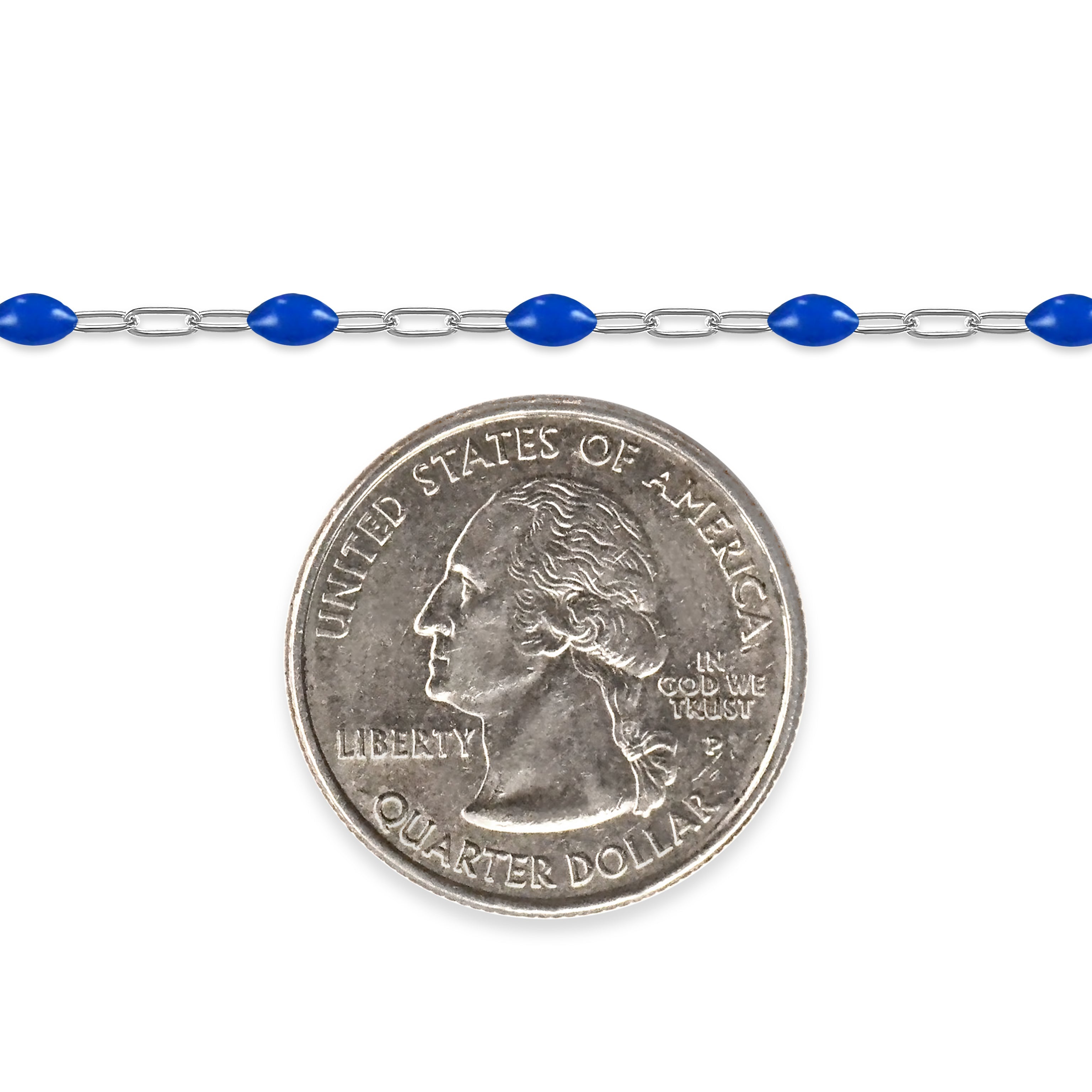Silver chain with blue enamel next to a quarter on a white background