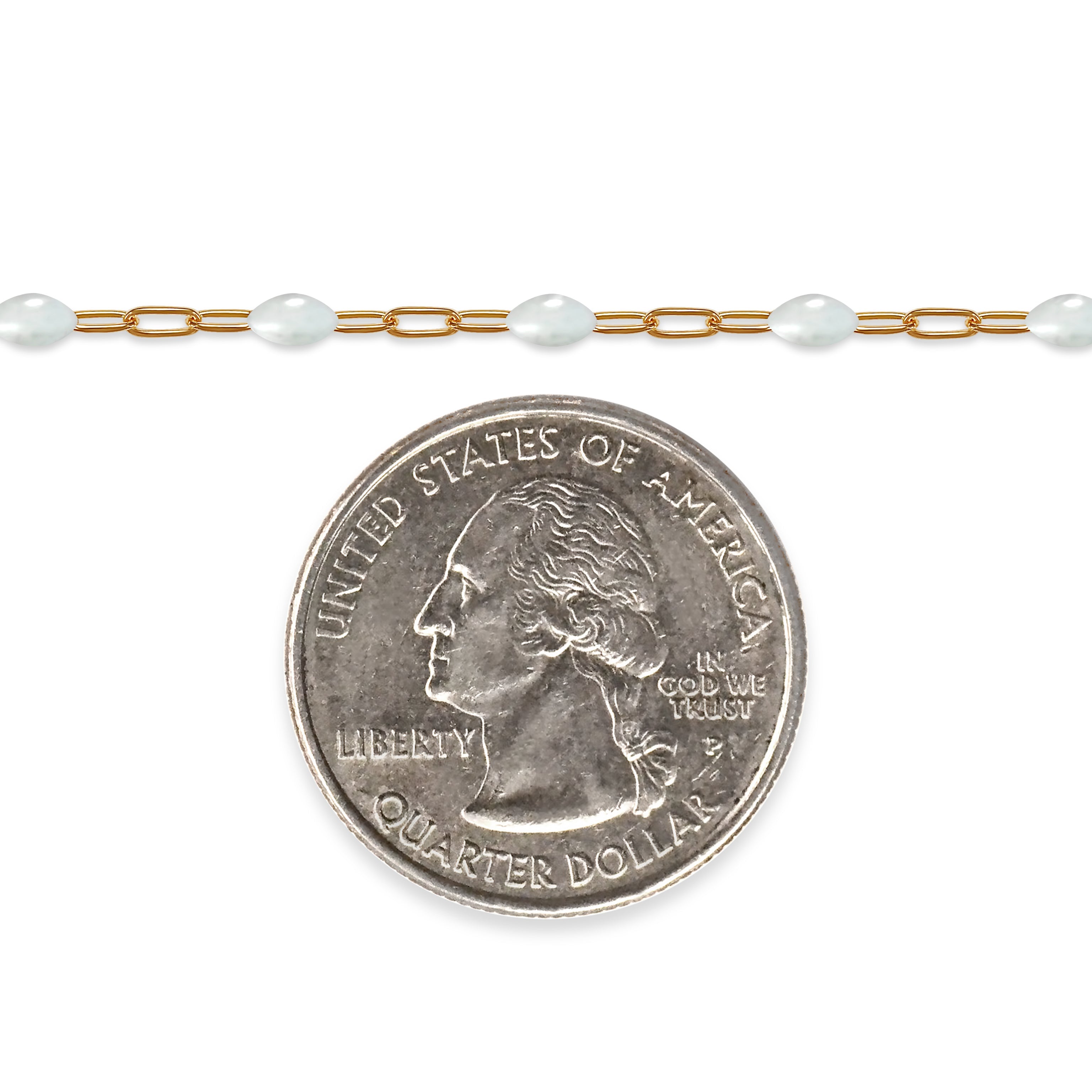 Gold filled chain with white enamel next to a quarter on a white background