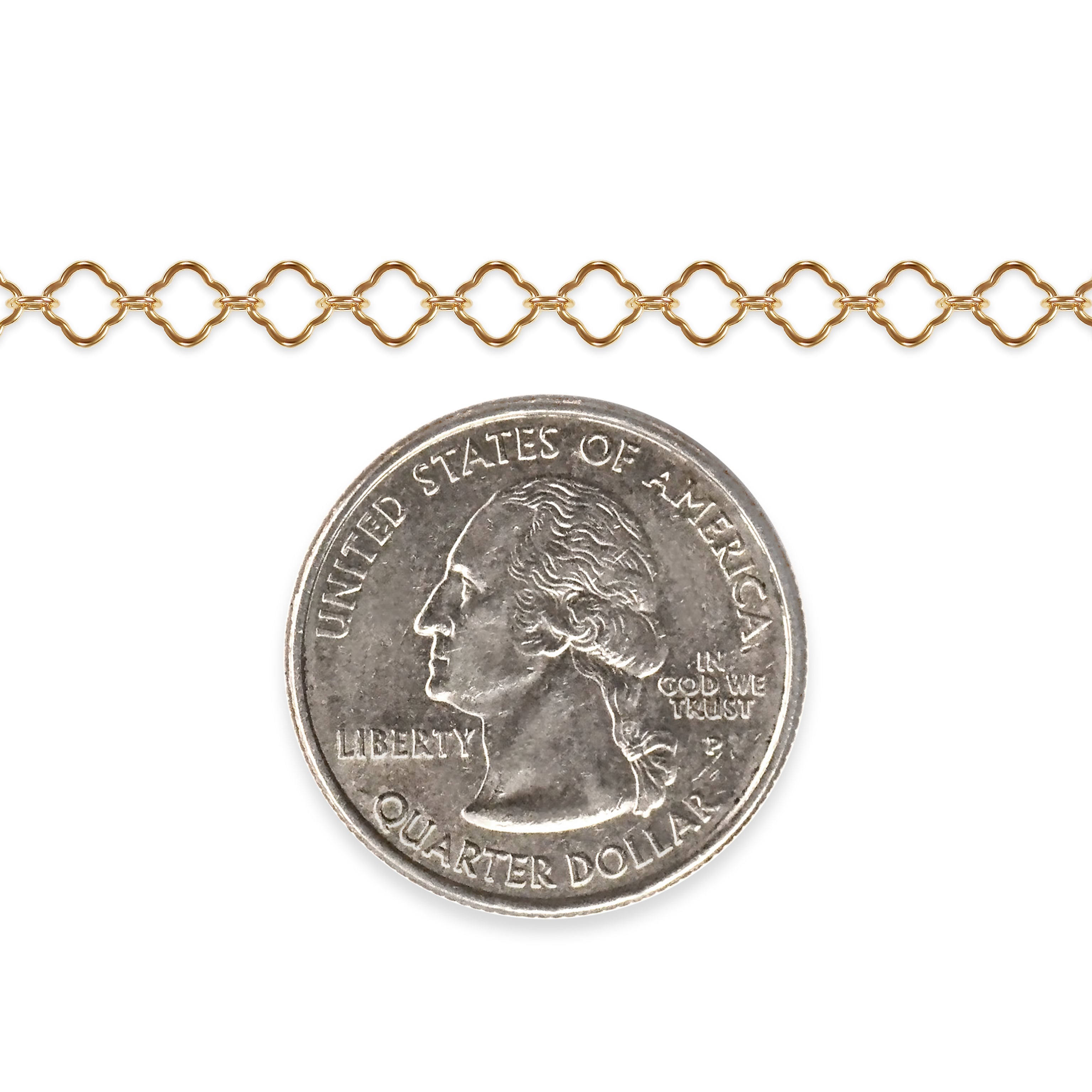 Gold filled clover chain with a quarter dollar coin on a white background