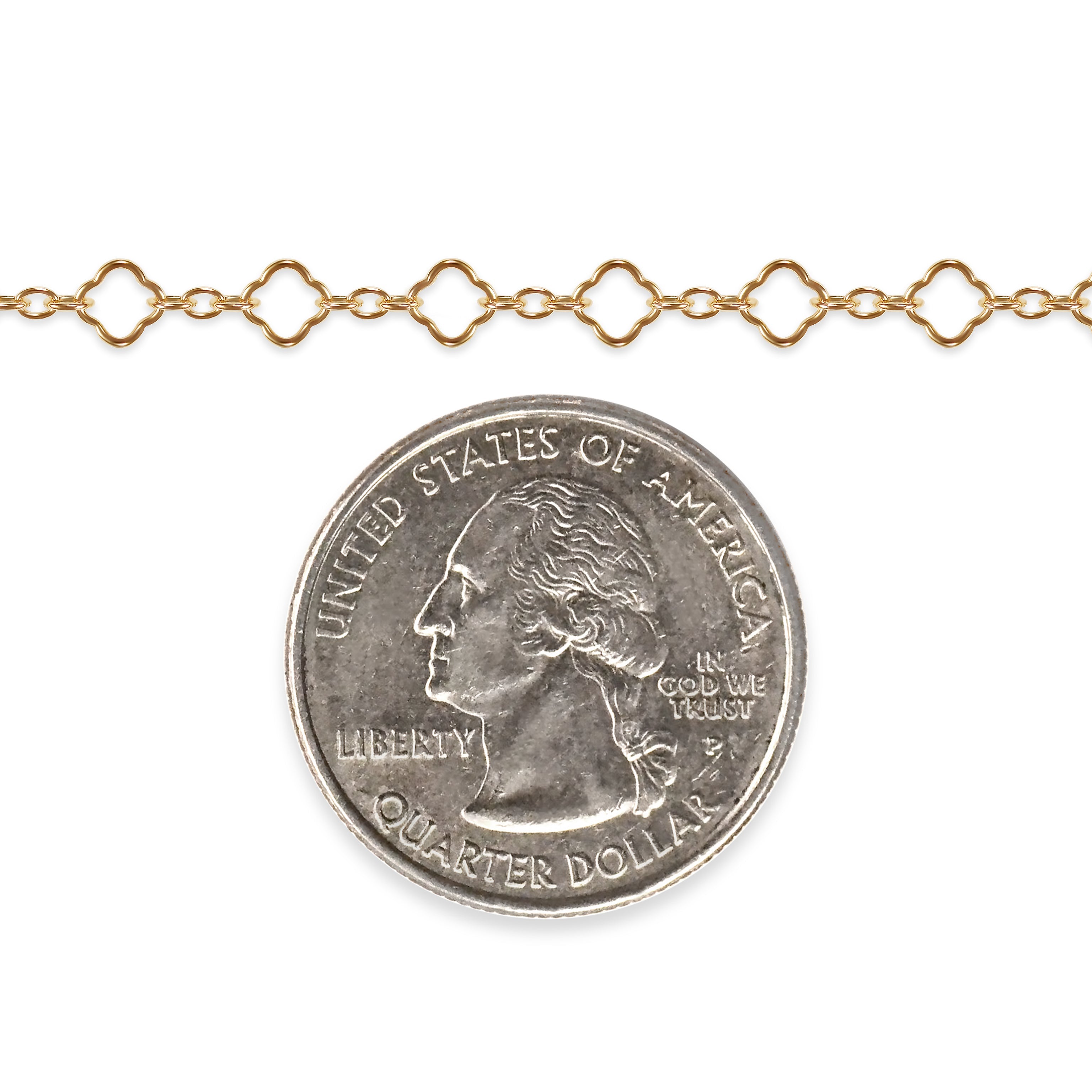 Gold filled clover chain with a quarter dollar coin on a white background