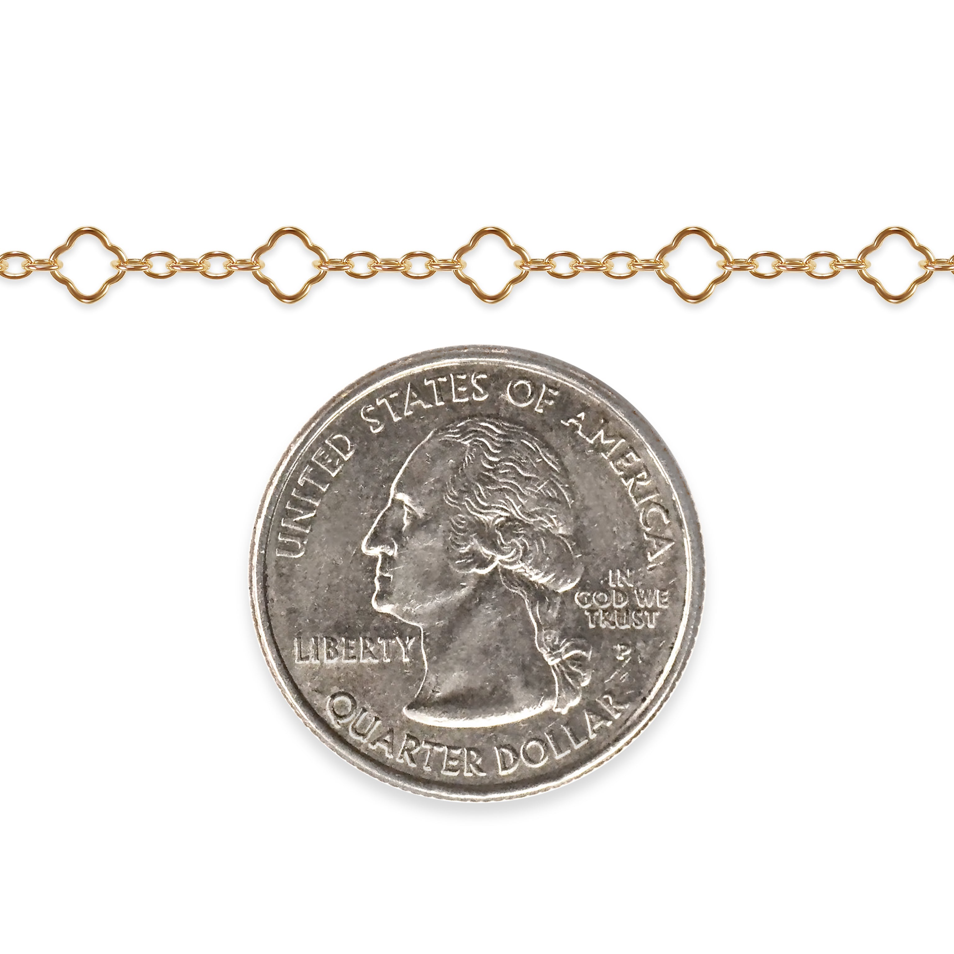 Gold filled clover chain with a quarter dollar coin on a white background