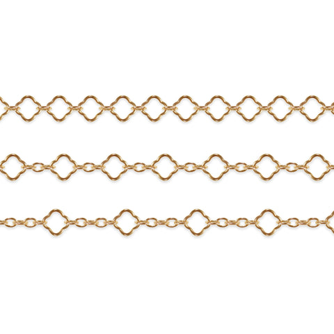 Gold filled clover chains on a white background